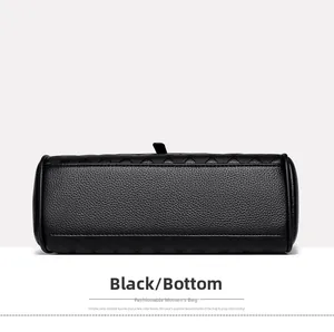 Detailed bottom view of black litchi grain leather bag with elegant quilted pattern