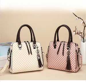 Detail of printed geometric tote bags with tassels and adjustable straps in a luxury setting