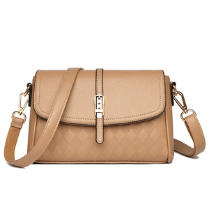 Close-up of khaki pebbled leather shoulder bag with diamond quilted stitch detailing