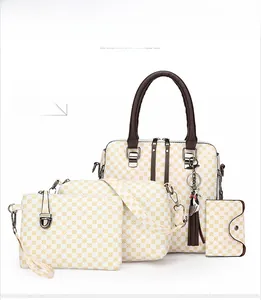 Detail of four-piece handbag set with yellow geometric pattern and brown round handles