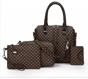 Detail of 4-piece dark brown printed bag set with tote, crossbody bag and cat charm