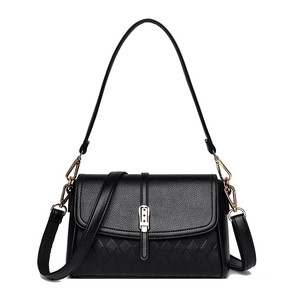 Elegant black lychee leather handbag with quilted details and gold hardware