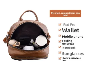 Spacious interior of brown PU leather backpack holding an iPad, umbrella and cosmetics