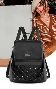 Detail of vintage black soft leather backpack with quilted pattern and gold studs