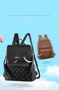 Close-up of lightweight black quilted leather backpack with gold rivets weighing 0.5kg