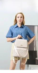 Cream quilted leather backpack for women with gold studs and a vintage flip cover design