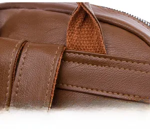 Macro shot of fine double stitching and premium PU leather texture on brown travel backpack