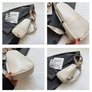 Detail view of cream PU leather crossbody bag with geometric woven strap and dark zippers