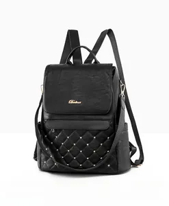 Close-up of black PU leather backpack with gold rivets and quilted diamond pattern