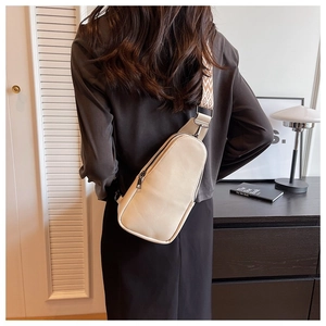 Beige PU leather crossbody sling bag featuring a bohemian style woven jacquard strap