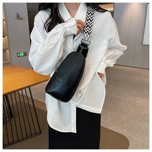 Minimalist black PU leather chest bag with a stylish black and white woven strap