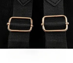Detail of adjustable black woven shoulder strap with premium gold metal buckle and leather