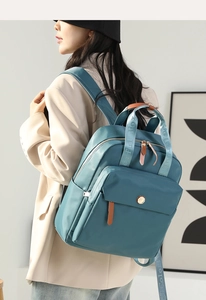 Blue nylon backpack detail showing durable waterproof texture and large capacity design