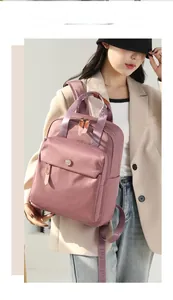 Fashionable pink nylon backpack for women shown with a stylish casual outfit for travel