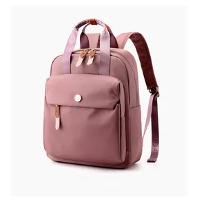 Micro side view of dusty rose nylon backpack with leather accents and woven handles