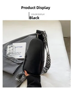 Detail of black PU leather crossbody bag with geometric woven strap and metallic zipper
