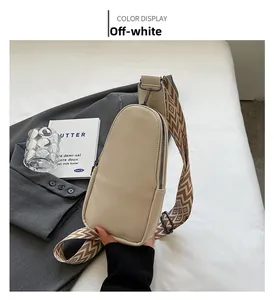 Chic beige PU leather chest bag with a geometric pattern strap on a gray blazer