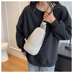 Detail of cream PU leather chest bag featuring wide jacquard woven shoulder strap