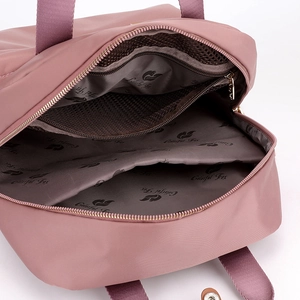 Internal view of nylon backpack featuring mesh pocket and organized storage compartments