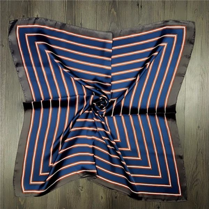 Blue and orange geometric striped square silk scarf on vintage wood background