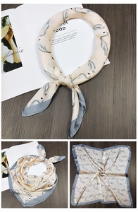 Champagne silk scarf featuring grey swan prints and professional border detailing