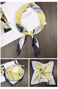 Detail of yellow silk scarf featuring black geometric patterns and Eiffel Tower design