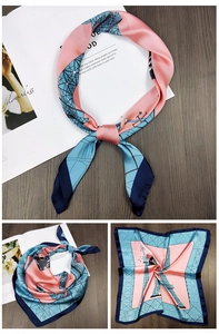 Detailed view of square silk scarf with Eiffel Tower print and geometric patterns