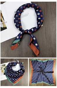 Detail of silk-like square scarf featuring horse patterns and contrast rolled edges