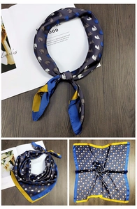 Detail of satin square scarf featuring horse head prints and contrasting yellow-blue borders