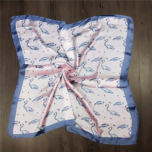 Pink satin square scarf featuring blue flamingo and feather prints with contrast borders