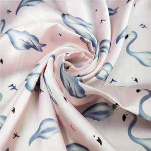 Pink silk neck scarf featuring blue flamingo prints with a smooth glossy texture finish