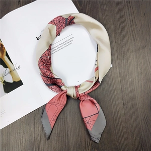 Detail of silk-like square scarf with geometric Eiffel Tower print in champagne gold