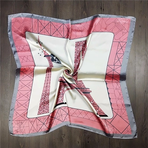 Detailed macro view of the silky square scarf with Eiffel Tower print and pink grid