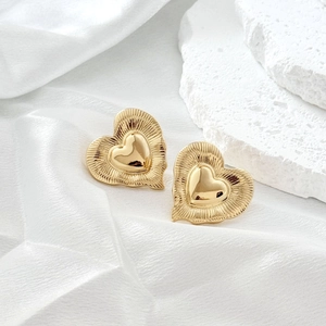 Minimalist 18K gold geometric heart stud earrings with radiant textured metal sunburst frame