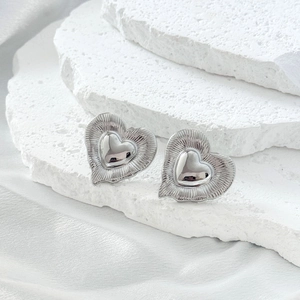 Minimalist double layered heart stud earrings with silver radiant texture on stone base