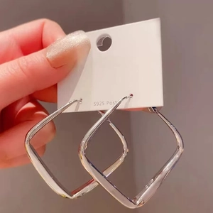 Polished silver geometric square hoop earrings with S925 posts on a white display card