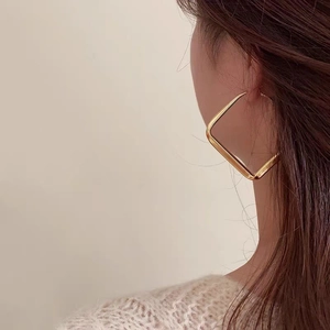 Minimalist gold geometric square hoop earrings for women shown on model side profile
