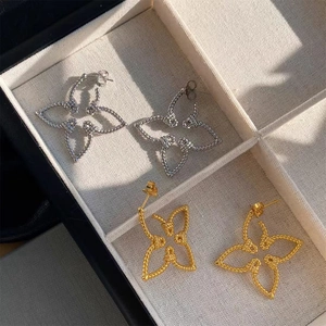Luxe 18K gold and silver hollow butterfly stud earrings with twisted rope texture details