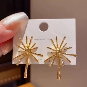 Unique gold firework starburst earrings with S925 silver posts shown on a display card