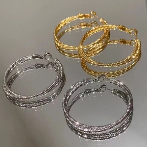 Grandi orecchini a cerchio in oro 18K e argento con finitura superficiale scintillante