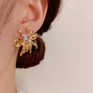 Vintage floral stud earrings with purple zircon in gold plating worn by model