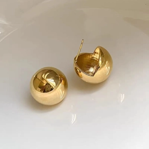 Minimalist 18K gold spherical stud earrings with a high-polished mirror finish