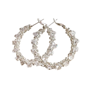 Sparkling 925 silver hoop earrings with cubic zirconia stones on a white background
