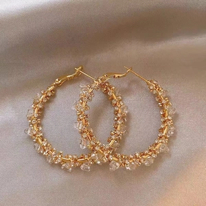 Minimalist 925 silver needle gold hoop earrings with sparkling crystals on beige silk