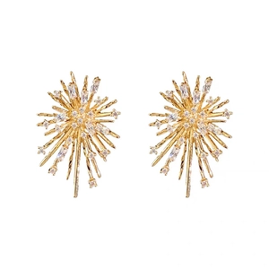 Golden firework starburst stud earrings with brilliant zircon stones on white background