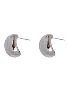 Macro detail of silver bean-shaped earrings featuring a high-polish metallic finish