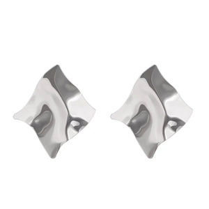 Macro detail of irregular silver earrings featuring liquid metal wave texture design
