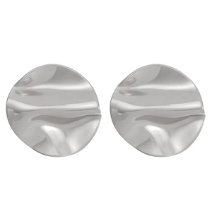 Macro detail of irregular hammered texture on silver-tone vintage round stud earrings