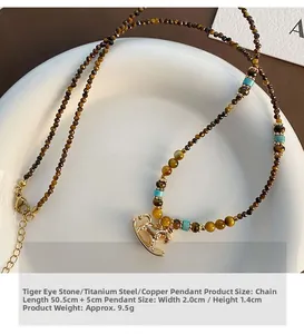 Detailed view of tiger eye bead necklace with golden rocking horse pendant and size labels