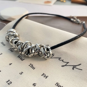 Minimalist black cord necklace with interlocking silver metal rings for a modern cool look
